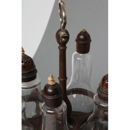 509 - A GEORGIAN HARDWOOD FIVE BOTTLE CRUET AND STAND, late 18th century, the original clear glass baluste... 