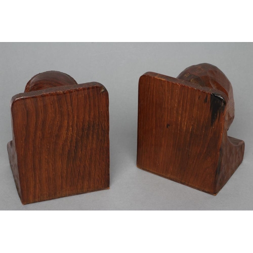 516 - A PAIR OF THOMAS WHITTAKER OF LITTLEBECK ADZED OAK BOOK ENDS of dished oblong form, each carved with... 