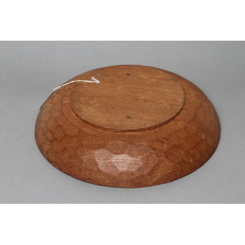 517 - A ROBERT THOMPSON ADZED OAK BOWL of shallow circular form, carved mouse trademark in high relief to ... 