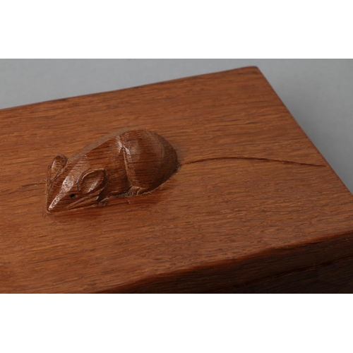 519 - A ROBERT THOMPSON ADZED OAK TRINKET BOX of oblong form, carved mouse trademark in high relief on det... 