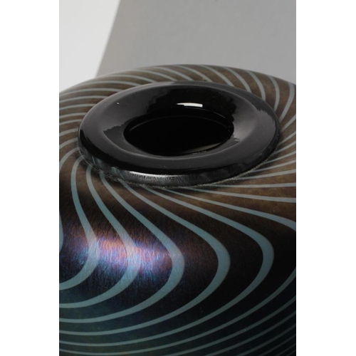 53 - DAVID WALLACE - a peacock iridescent glass vase with swirled lines, of flared rounded conical form, ... 