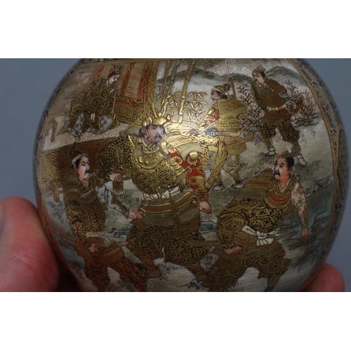 6 - A SATSUMA EARTHENWARE VASE of globular form, painted in typical palette and richly gilded with two p... 