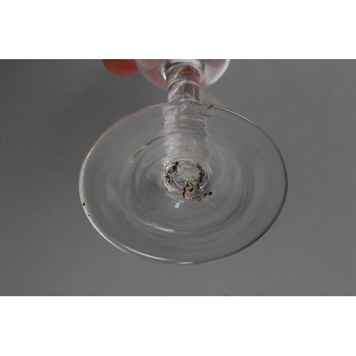 61 - A CORDIAL GLASS, mid 18th century, the ogee bowl engraved with a flower and butterfly, raised upon a... 