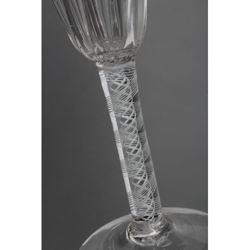 76 - A WINE GLASS, mid 18th century, the semi-wrythen mould blown round funnel bowl on an opaque twist st... 