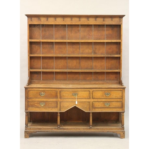 775 - AN OAK DRESSER, early 19th century, the boarded delft rack with moulded cornice and frieze with iron... 