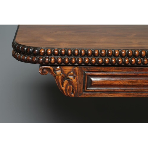 776 - A GEORGE IV ROSEWOOD FOLDING TEA TABLE, the rounded oblong swivel top with beaded edging, panelled f... 