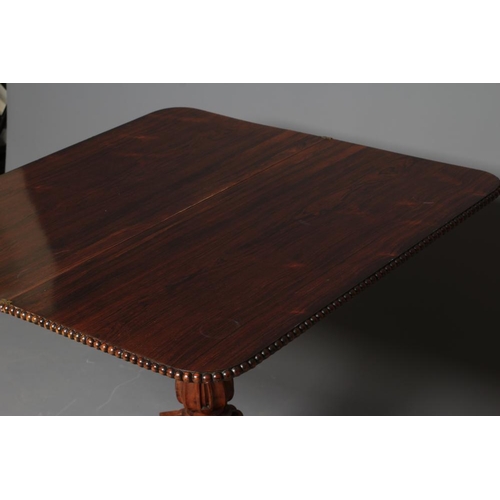 776 - A GEORGE IV ROSEWOOD FOLDING TEA TABLE, the rounded oblong swivel top with beaded edging, panelled f... 