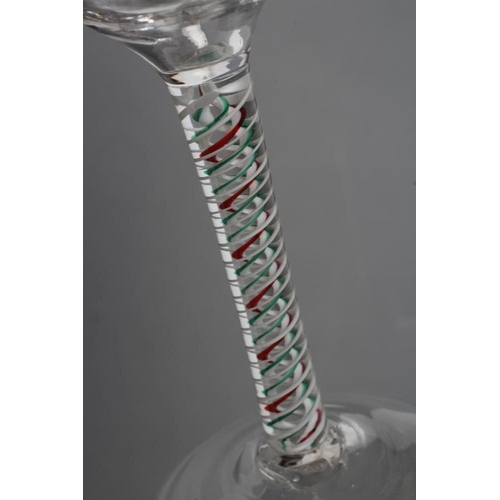 87 - A CORDIAL GLASS, mid 18th century, the ogee bowl on multi-ply opaque twist stem with a red and green... 