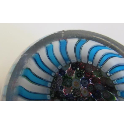 55 - A CLICHY GLASS PAPERWEIGHT, the close millefiori coloured canes over a turquoise and striped cane ba... 