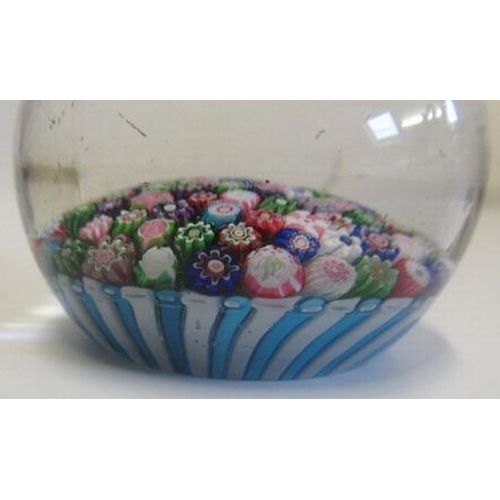 55 - A CLICHY GLASS PAPERWEIGHT, the close millefiori coloured canes over a turquoise and striped cane ba... 