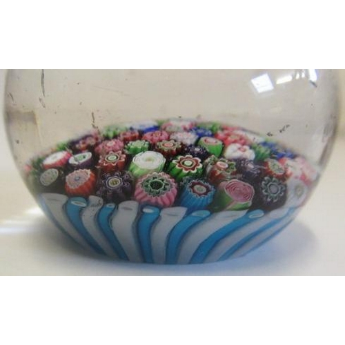 55 - A CLICHY GLASS PAPERWEIGHT, the close millefiori coloured canes over a turquoise and striped cane ba... 