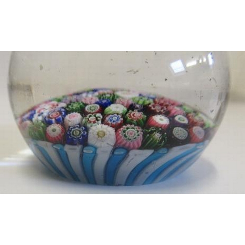 55 - A CLICHY GLASS PAPERWEIGHT, the close millefiori coloured canes over a turquoise and striped cane ba... 