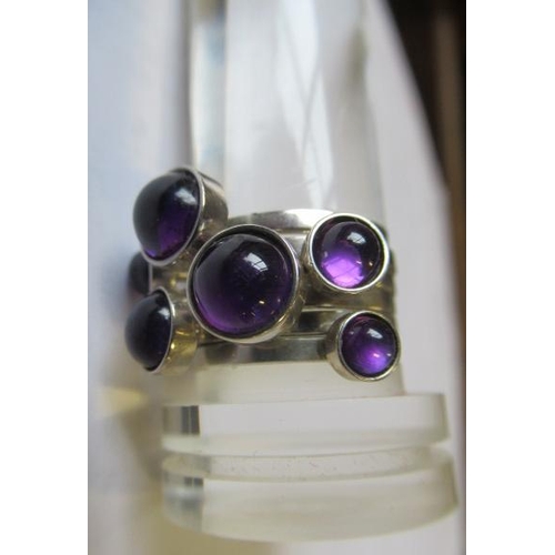 402 - A WENDY RAMSHAW SILVER AND AMETHYST STACKING RING, the six plain rings each set with a graduated clo... 