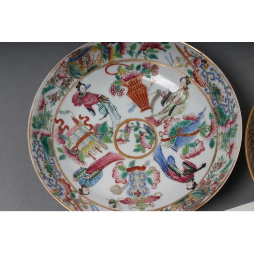 16 - A CHINESE PORCELAIN FAMILLE ROSE SAUCER painted with three figures in a garden within a blue and gil... 