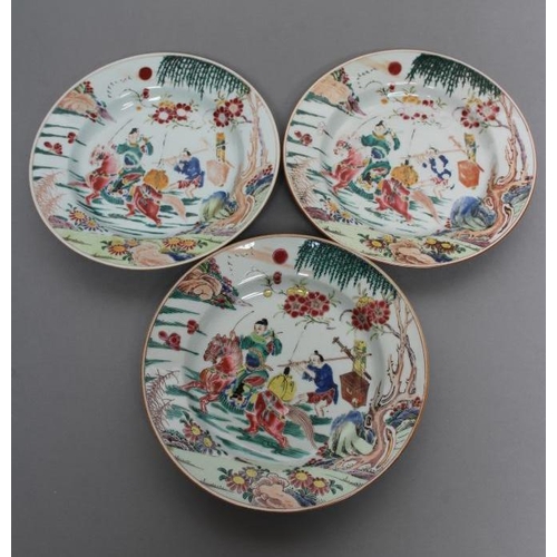 17 - A SET OF THREE CHINESE PORCELAIN FAMILLE ROSE PLATES painted with a horseman fording a stream, his s... 