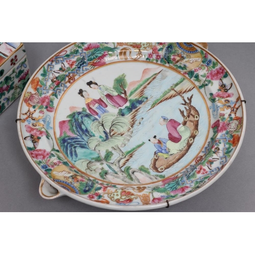 2 - A CANTONESE PORCELAIN WARMING DISH of circular form with two small spouts, painted in famille rose e... 