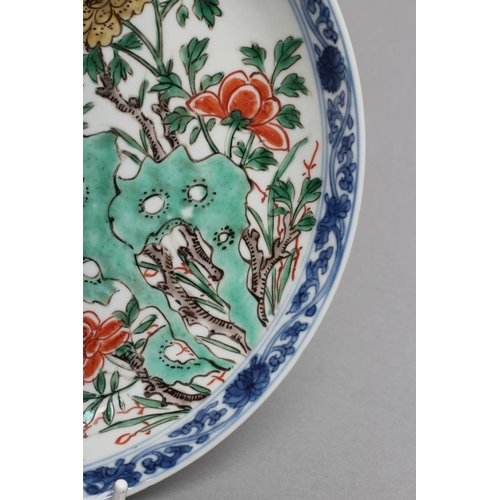 21 - A CHINESE PORCELAIN SAUCER DISH of plain circular form, painted in colours with rockwork and floweri... 