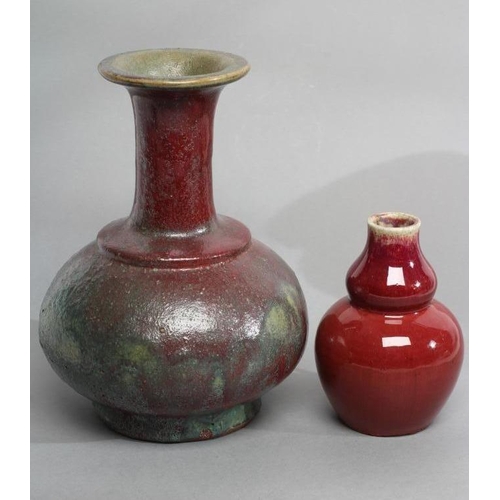 22 - A CHINESE STONEWARE VASE of double gourd form in a sang de boeuf glaze, 5 1/2