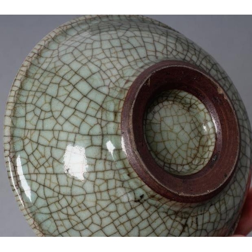 23 - A CHINESE CELADON GLAZED SMALL DISH of lobed circular form, centrally carved with a flower spray, 5 ... 