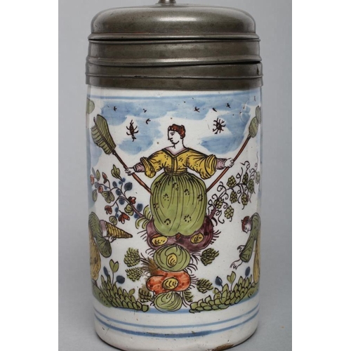 25 - A GERMAN FAIENCE STEIN, mid 18th century, of plain cylindrical form painted in colours with a centra... 