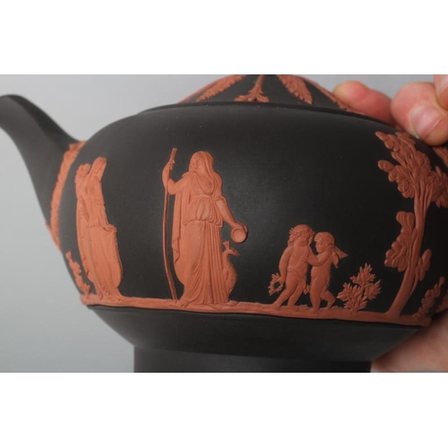 49 - A WEDGWOOD ROSSO ANTICO TEAPOT AND COVER, 1988, of squat globular form, with classical figure sprigg... 