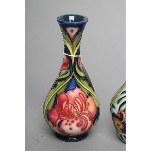 82 - THREE MOORCROFT POTTERY SMALL VASES, comprising a globular example with art nouveau style flowerhead... 