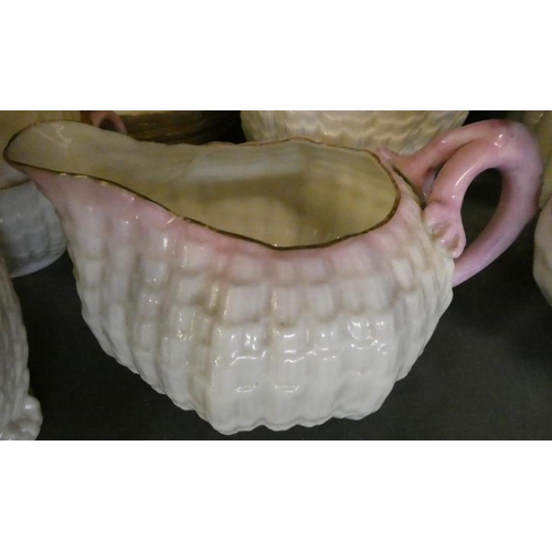 42 - A VICTORIAN FIRST PERIOD BELLEEK PORCELAIN NAUTILUS TEA SERVICE with shaded pink rims, comprising si... 