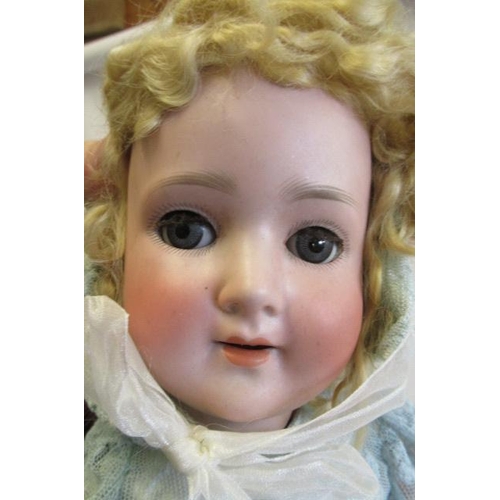 1 - A Schoenau & Hoffmeister bisque socket head doll, with blue glass sleeping eyes, open mouth, teeth, ... 