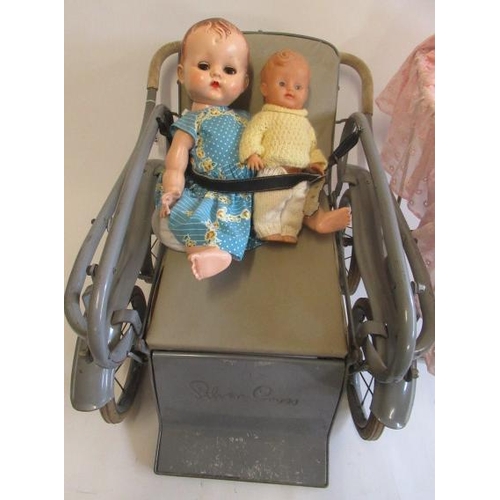 103 - A 1950s Silver Cross dolls pram, together with a vintage cradle and four dolls including three cellu... 