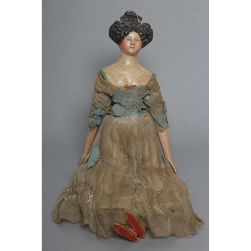 105 - A papier mache doll, c.1830, shoulder head with moulded hair and painted features, shaped and painte... 