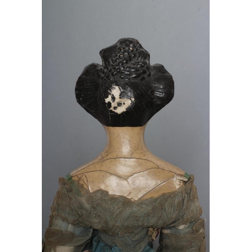 105 - A papier mache doll, c.1830, shoulder head with moulded hair and painted features, shaped and painte... 