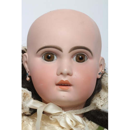 114 - A Tete Jumeau bisque socket head doll, with brown glass fixed eyes, open mouth, moulded teeth, pierc... 