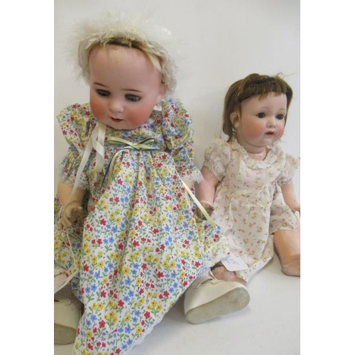 115 - Two bisque socket head character dolls, comprising one 24