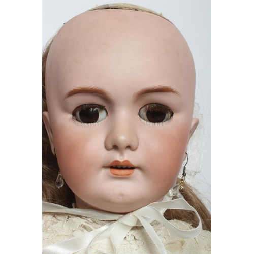 123 - A large DEP bisque socket head doll, with brown glass sleeping eyes, open mouth, moulded teeth, pier... 