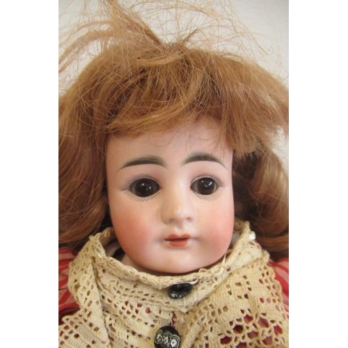 125 - A German bisque shoulder head doll, possibly Kestner, with brown glass sleeping eyes, open mouth, te... 