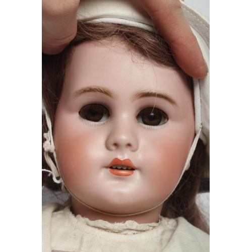 128 - A Bebe Jumeau bisque socket head doll, with brown glass sleeping eyes, open mouth, moulded teeth, pi... 