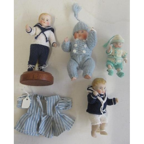 142 - Four Kestner all bisque small dolls, all five piece jointed, all in woollen clothes, one standing, l... 