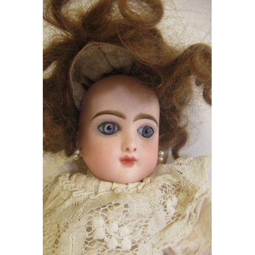 153 - A Bebe Jumeau bisque socket head doll, with blue glass paperweight fixed eyes, closed mouth, pierced... 