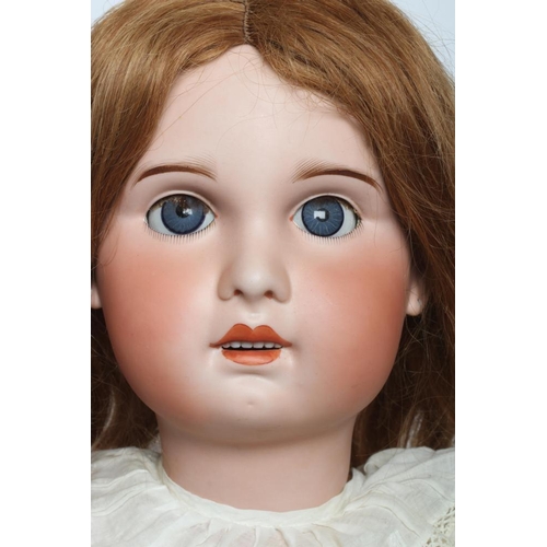 157 - A large SFBJ bisque socket head doll, with blue glass sleeping eyes, open mouth, teeth, pierced ears... 