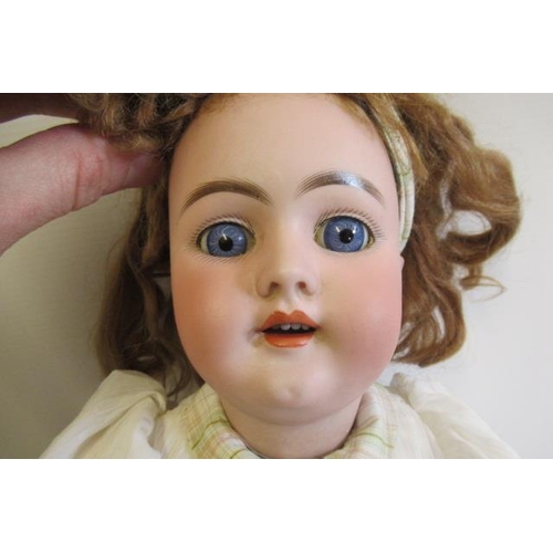 17 - A Heinrich Handwerck bisque socket head doll, with blue glass fixed eyes, open mouth, applied teeth,... 