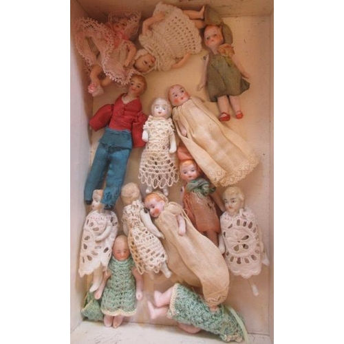 176 - Thirteen doll's house dolls, all jointed, two celluloid and the rest bisque, all with moulded and or... 