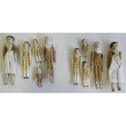 177 - A collection of miniature peg dolls, with painted features and jointed bodies, four later and the re... 