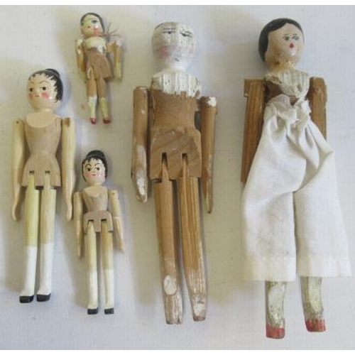 177 - A collection of miniature peg dolls, with painted features and jointed bodies, four later and the re... 