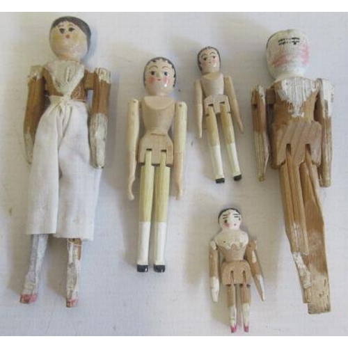 177 - A collection of miniature peg dolls, with painted features and jointed bodies, four later and the re... 