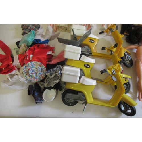 197 - Eleven Sindy dolls, of mixed ages, together with a small quantity of clothing and three mopeds (Est.... 