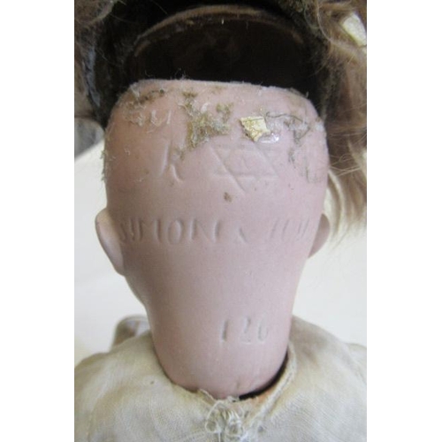 20 - A Kammer & Reinhardt bisque socket head doll, with brown glass eyes, open mouth, teeth, brown wig, w... 