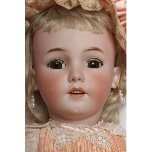 200 - A large Simon & Halbig bisque socket head doll, with brown glass sleeping eyes, open mouth, teeth, p... 