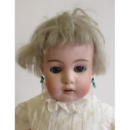 206 - A German bisque shoulder head doll, with brown glass sleeping eyes, open mouth, teeth, pierced ears,... 