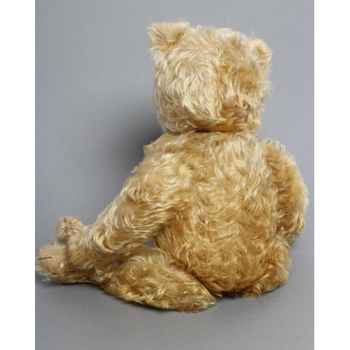 216 - A pre-war German long haired jointed teddy bear, with orange plush, amber glass eyes, sewn nose, fel... 