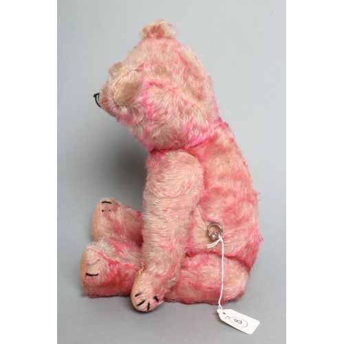 218 - A pre-war pink musical jointed teddy bear, with wind-up mechanism, pink plush, amber eyes, sewn nose... 